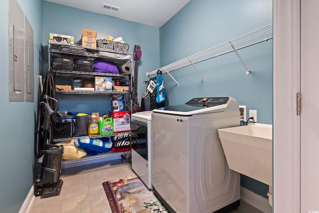338 Harbour View Dr, Myrtle Beach, SC 29579 - laundry room featuring washing machine and clothes dryer, electric panel, and tile patterned floors