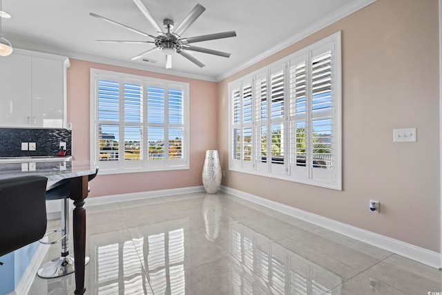 338 Harbour View Dr, Myrtle Beach, SC 29579 - kitchen featuring ornamental molding, ceiling fan, baseboards, white cabinetry, and decorative backsplash