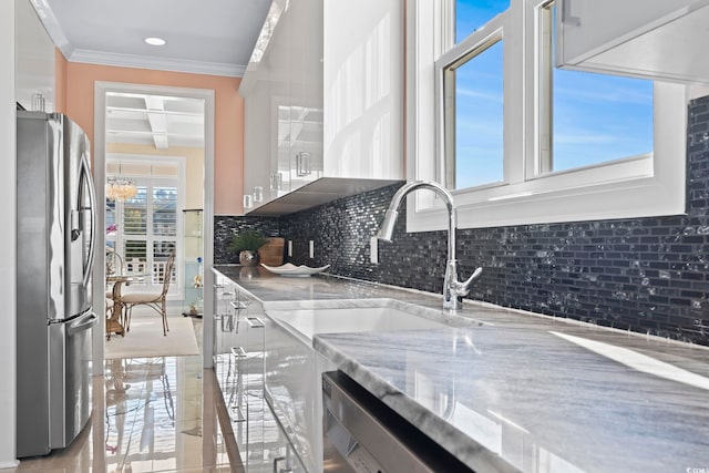 338 Harbour View Dr, Myrtle Beach, SC 29579 - kitchen featuring appliances with stainless steel finishes, tasteful backsplash, crown molding, light stone counters, and beamed ceiling