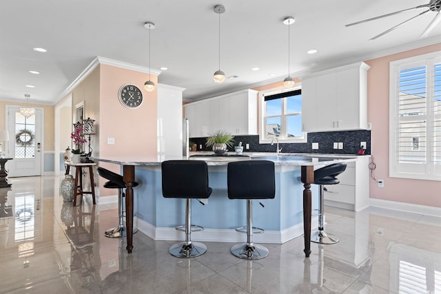 338 Harbour View Dr, Myrtle Beach, SC 29579 - kitchen featuring crown molding, tasteful backsplash, plenty of natural light, a breakfast bar, and recessed lighting
