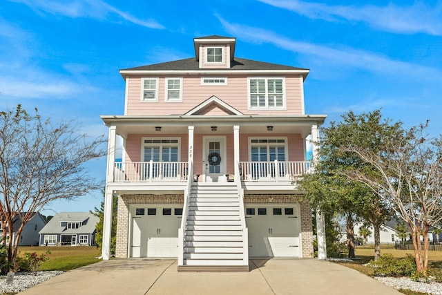 338 Harbour View Dr, Myrtle Beach, SC 29579 - coastal home with stairs, brick siding, an attached garage, a porch, and concrete driveway