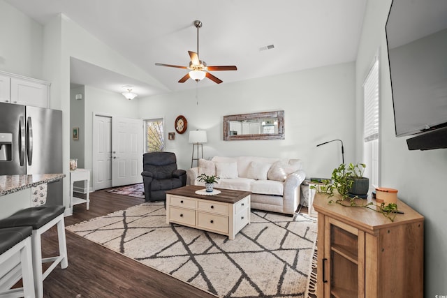 living room with hardwood / wood-style floors, ceiling fan, and lofted ceiling