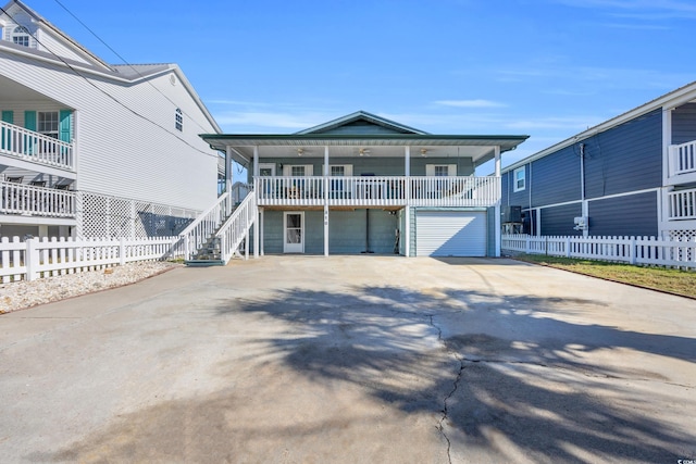 310 34th Ave N, North Myrtle Beach, SC 29582 - beach home with driveway, a porch, a garage, and stairway