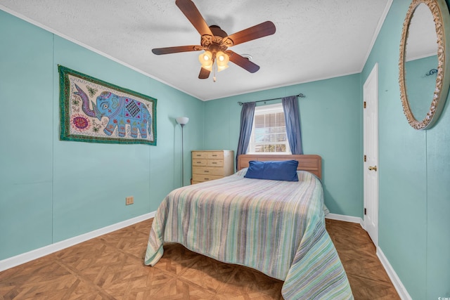 bedroom with parquet floors, a textured ceiling, ceiling fan, and crown molding