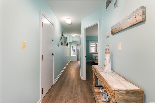 hall with dark hardwood / wood-style flooring