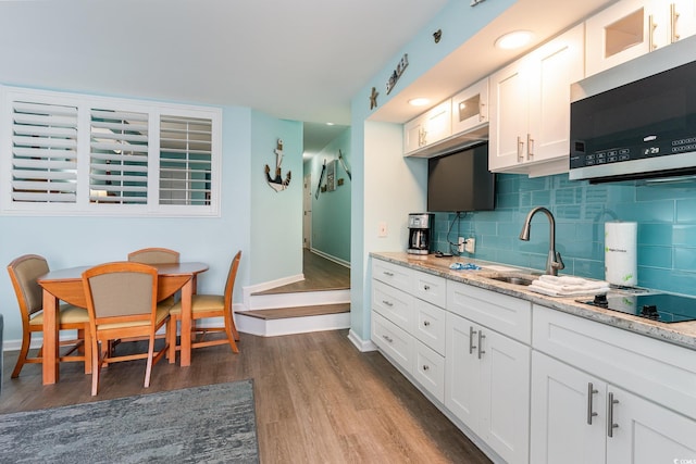 kitchen featuring white cabinets, sink, dark hardwood / wood-style floors, and black electric cooktop