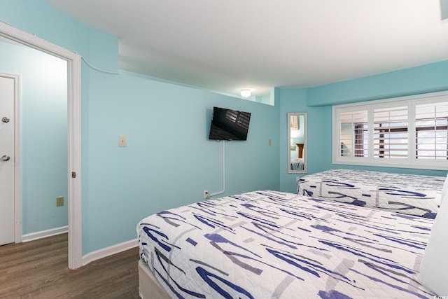 bedroom with dark hardwood / wood-style flooring