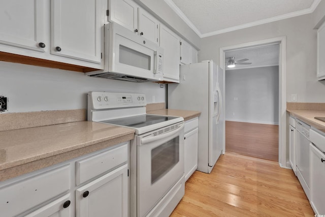 kitchen with a textured ceiling, white appliances, light hardwood / wood-style floors, and white cabinetry