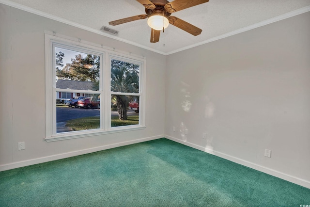 carpeted spare room featuring a textured ceiling, ceiling fan, and crown molding