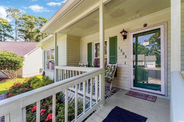 view of exterior entry featuring covered porch