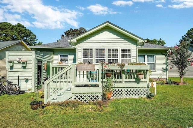 back of house featuring a wooden deck and a lawn