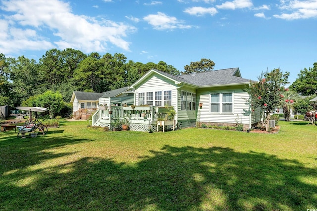 back of property featuring a yard and a wooden deck