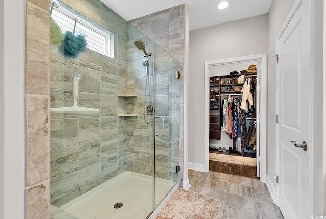 bathroom featuring a shower with door