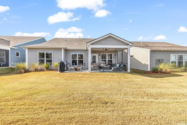 back of property featuring a lawn, ceiling fan, a patio, and a sunroom