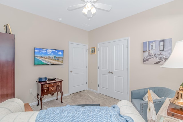 bedroom featuring a closet, ceiling fan, and light colored carpet