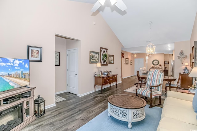 living room featuring hardwood / wood-style floors, high vaulted ceiling, and ceiling fan with notable chandelier