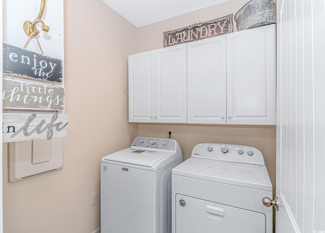 laundry area with cabinets and washing machine and clothes dryer