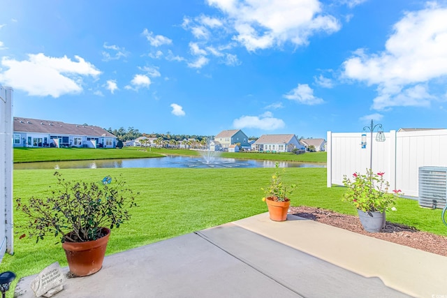 view of patio / terrace featuring central AC unit and a water view