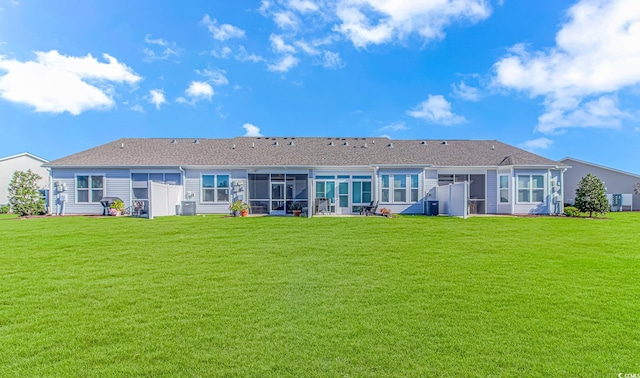 back of house with a lawn