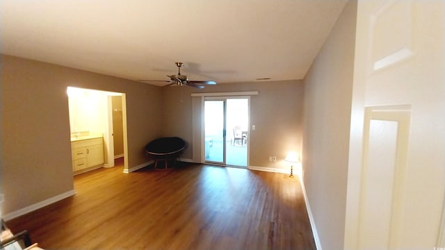 interior space with ceiling fan and wood-type flooring