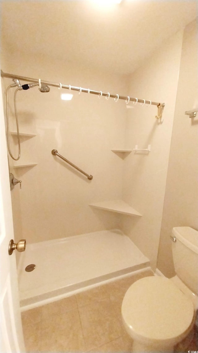 bathroom with tile patterned floors and a shower