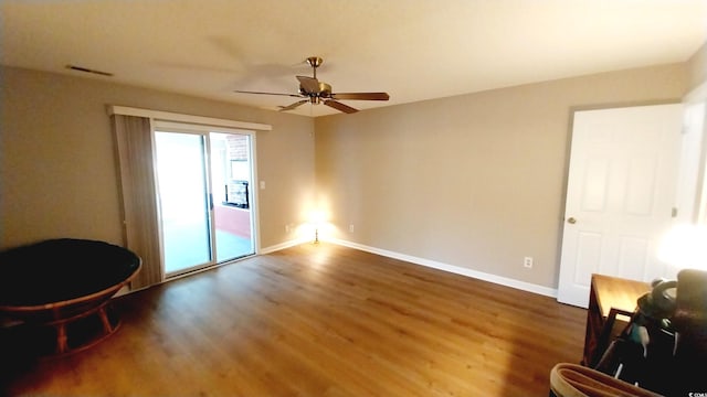 empty room featuring ceiling fan and dark hardwood / wood-style flooring