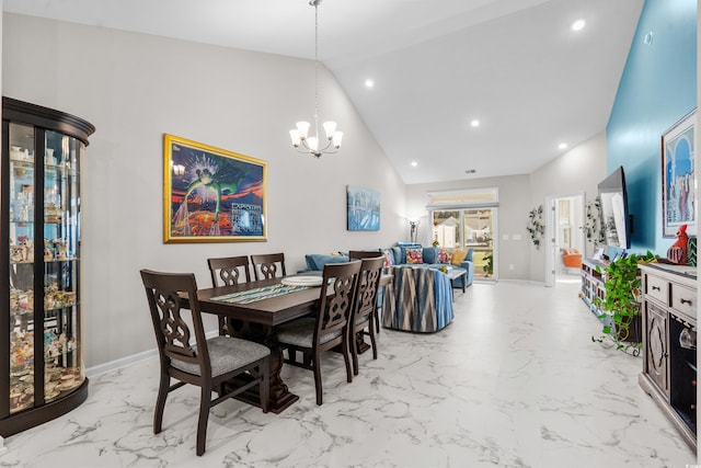 dining space with high vaulted ceiling and an inviting chandelier