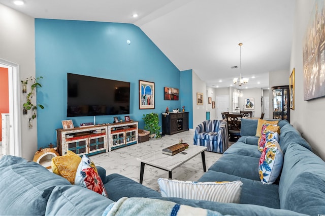 living room featuring high vaulted ceiling and a notable chandelier