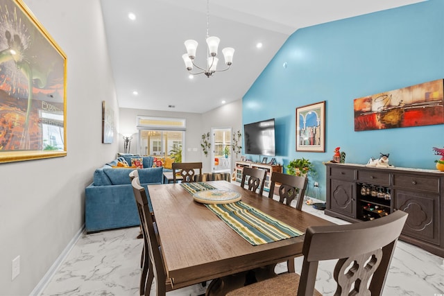 dining area with high vaulted ceiling and an inviting chandelier