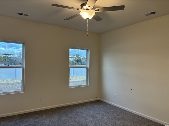 empty room featuring carpet floors and ceiling fan