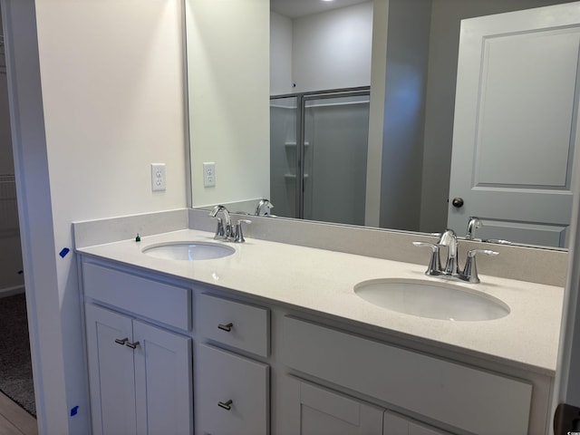 bathroom with an enclosed shower and vanity