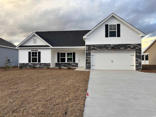 view of front of house featuring a garage and a front lawn