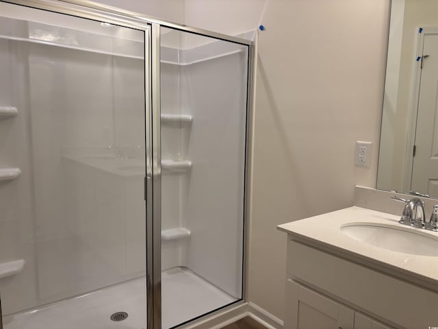 bathroom with vanity and a shower with shower door