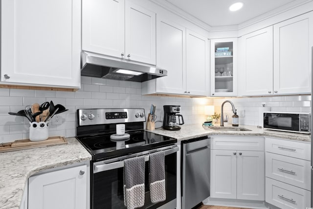 kitchen with backsplash, white cabinetry, sink, and stainless steel appliances