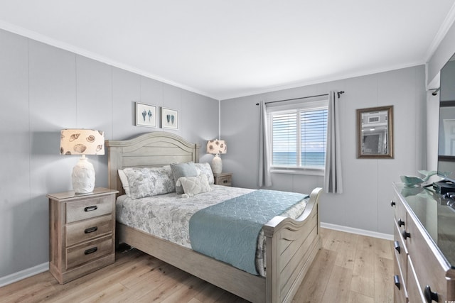 bedroom featuring light hardwood / wood-style floors and crown molding