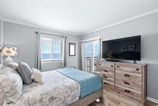 bedroom featuring access to exterior, crown molding, and light wood-type flooring