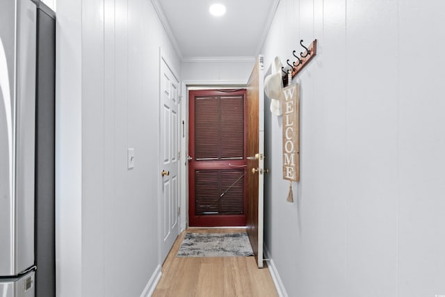 doorway featuring light hardwood / wood-style floors and ornamental molding