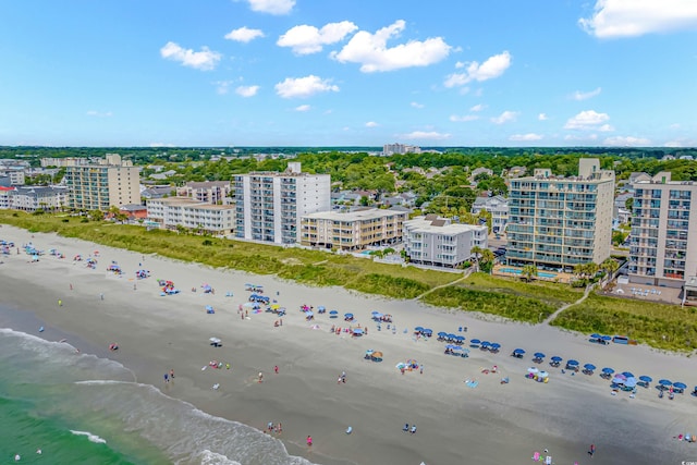 drone / aerial view featuring a beach view and a water view