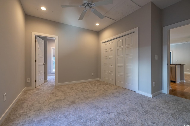 unfurnished bedroom featuring ceiling fan, light carpet, and a closet