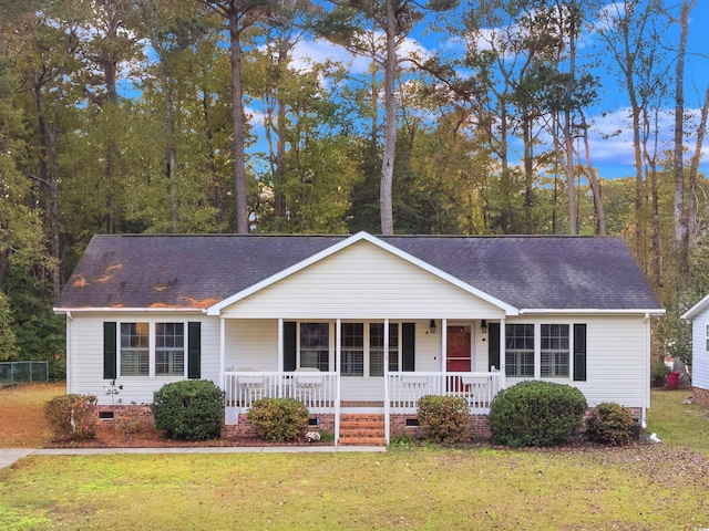 ranch-style home with crawl space, a shingled roof, a front lawn, and a porch