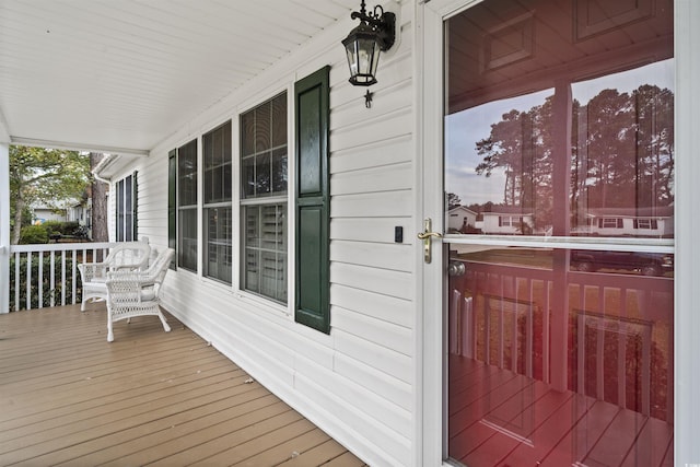 wooden terrace featuring covered porch