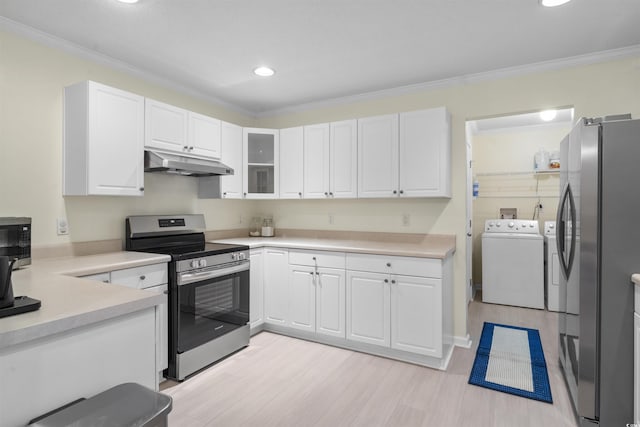 kitchen featuring appliances with stainless steel finishes, white cabinetry, under cabinet range hood, and washer and clothes dryer