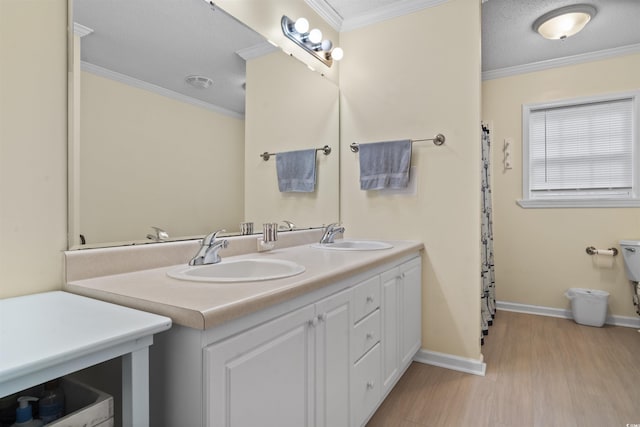 full bath with crown molding, a sink, and wood finished floors