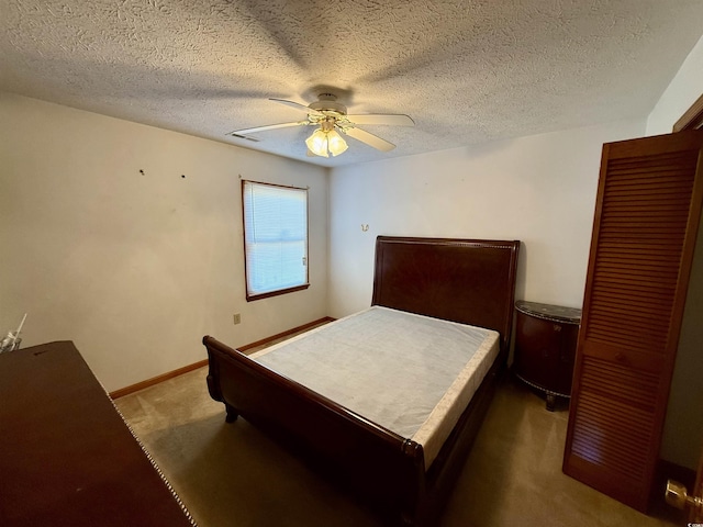 carpeted bedroom with ceiling fan and a textured ceiling