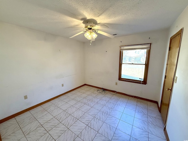 spare room featuring ceiling fan and a textured ceiling