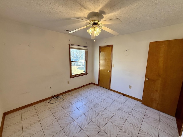 spare room featuring a textured ceiling and ceiling fan