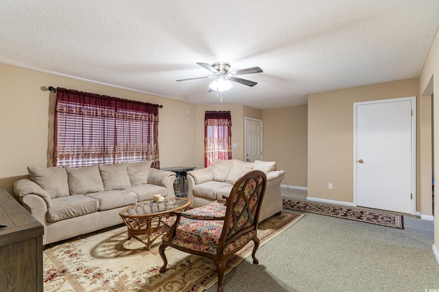 carpeted living room with ceiling fan and a textured ceiling