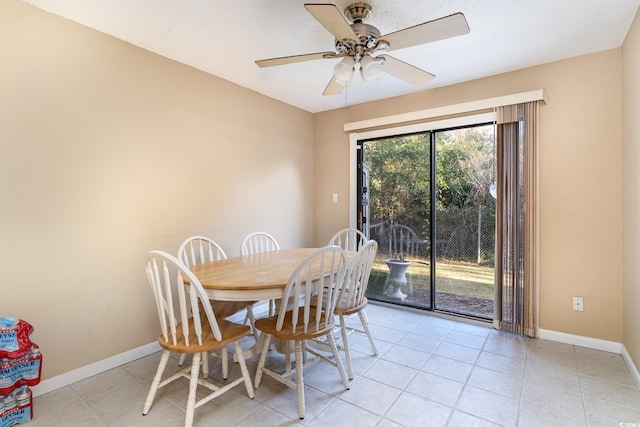 tiled dining space featuring ceiling fan