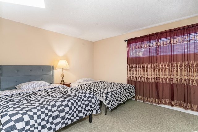 carpeted bedroom with a textured ceiling