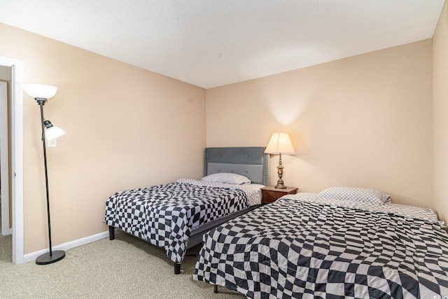 bedroom with a textured ceiling and light carpet